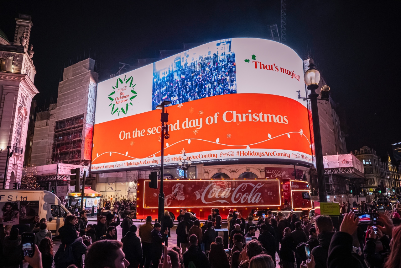 Coca-Cola leads carols in Piccadilly Circus to mark return of 'Holidays are coming' ad
